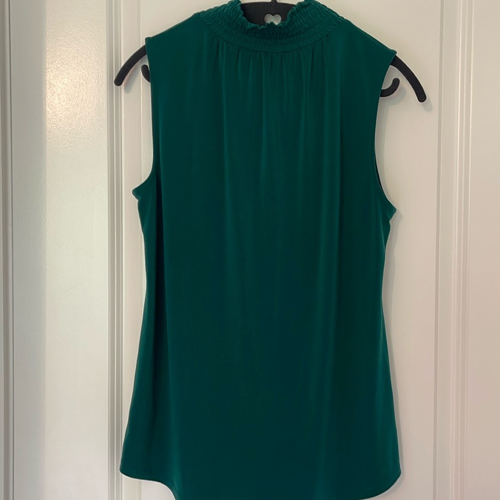 Dressy, green sleeveless shirt.
